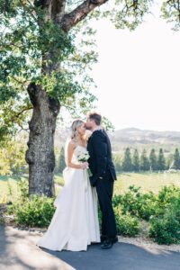 bride and groom kissing at winery wedding