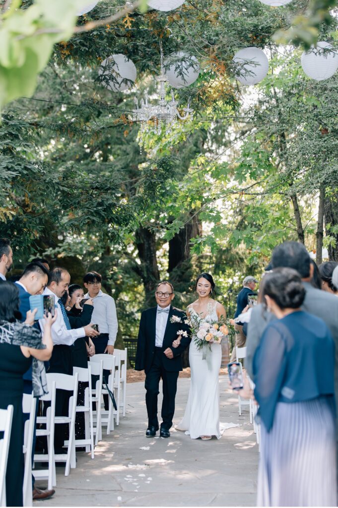 dad and bride walking down the aisle at vine hill house